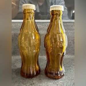 2/$30. Vintage amber coloured promotional Coca Cola salt and pepper shakers